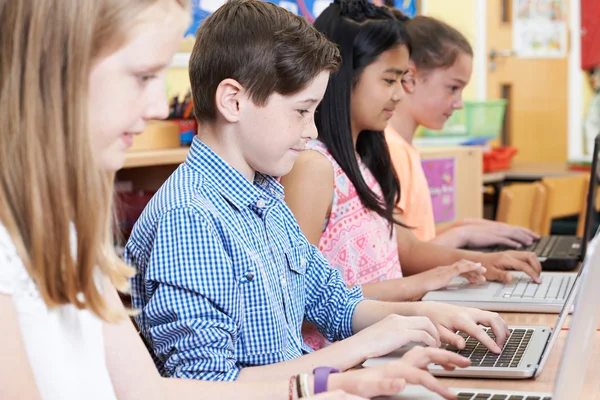 Group Of Elementary School Children In Computer Class