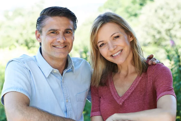 Outdoor Head And Shoulders Portrait Of Smiling Mature Couple