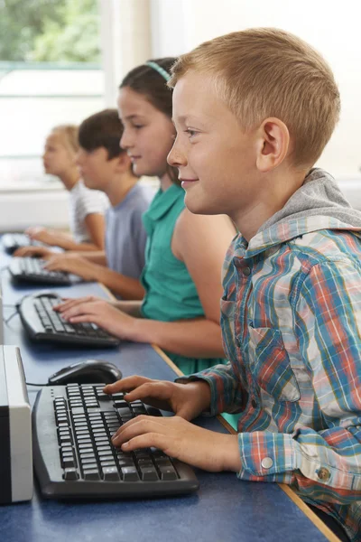 Group Of Elementary School Children In Computer Class