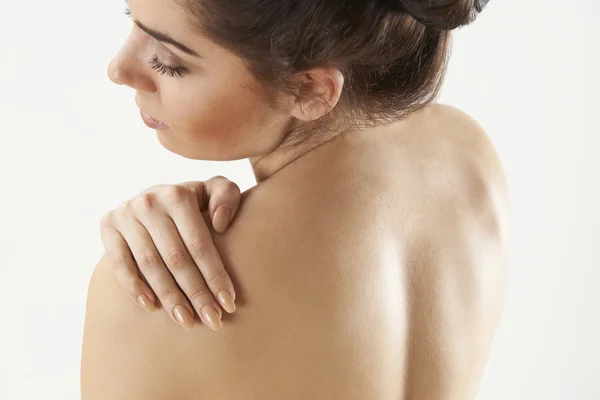 Studio Shot Of Woman With Painful Shoulder
