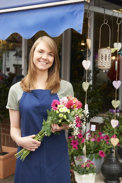 Florist Standing Outside Florist Shop With Bouquet