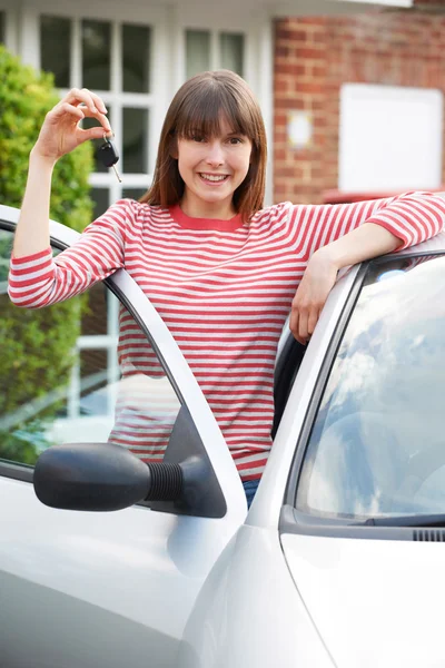 Smiling Young Woman Holding Keys To First Car