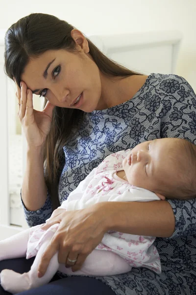 Portrait Of Tired Mother Suffering From Post Natal Depression