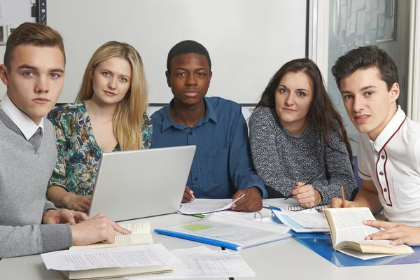 Group Of Teenage Pupils Working In Classroom