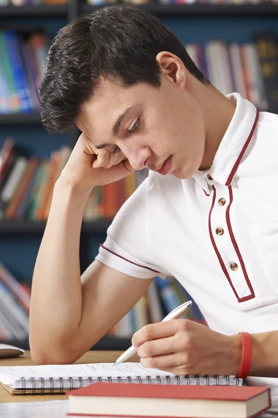 Fed Up Male Student Working In Library