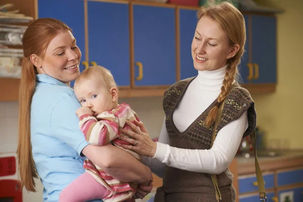 Working Mother Dropping Baby At Nursery