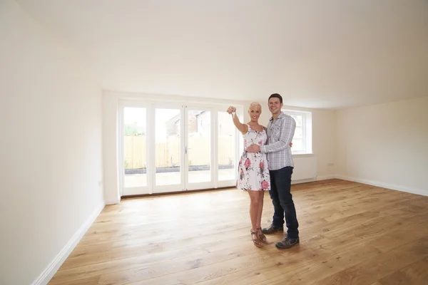 Young Couple With Keys To New Home