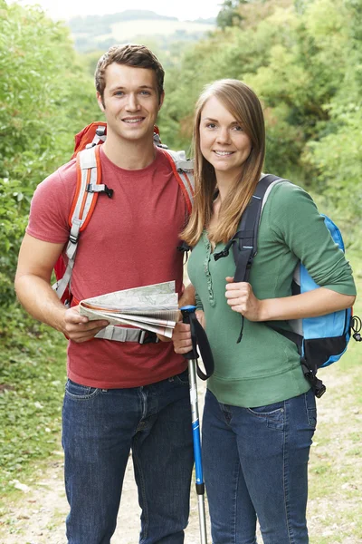 Portrait Of Young Couple Hiking In Countryside