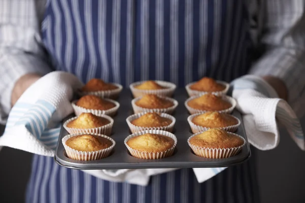 Man Holding Tray Of Freshly Baked Homemade Cupcakes