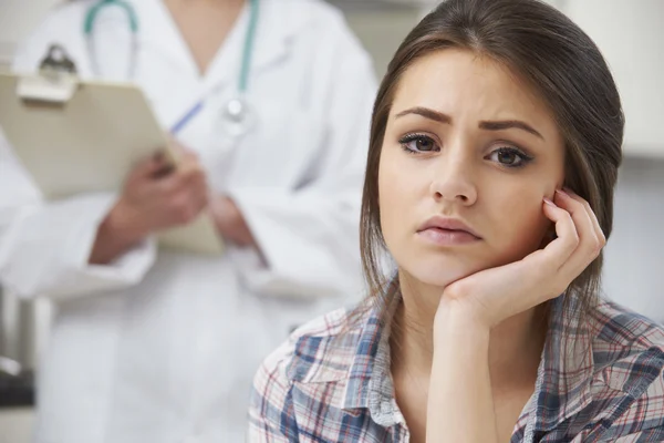 Teenage Girl With Appointment At Doctor's Surgery