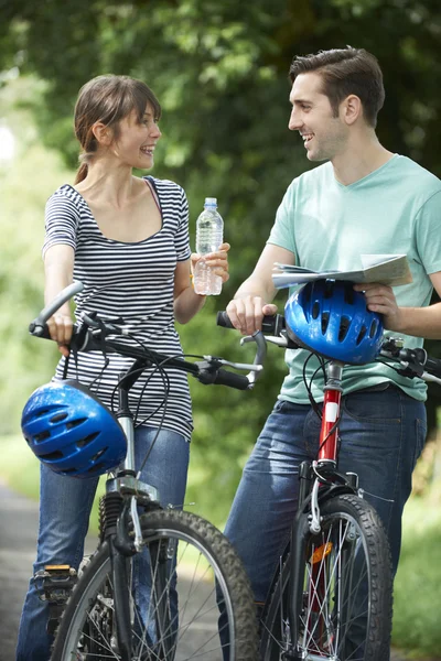 Young Couple Having Break Whilst On Country Cycle Ride
