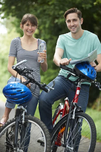 Young Couple Having Break Whilst On Country Cycle Ride