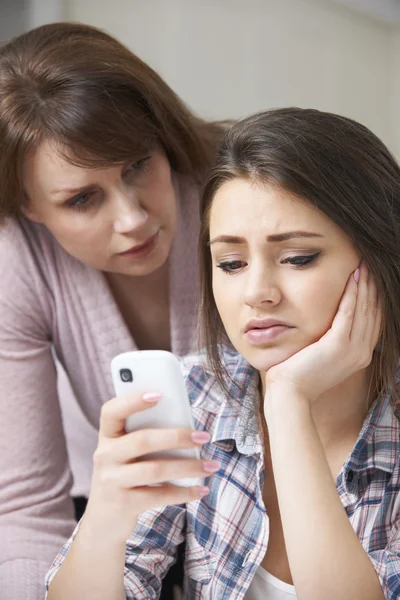 Mother Comforting Daughter Being Bullied By Text Message