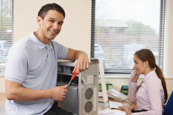 Computer IT Support Worker Fixing Machine In Office