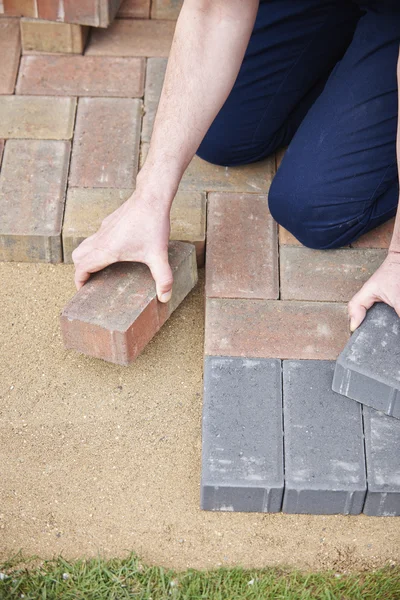 Man Laying Blocks For Patio