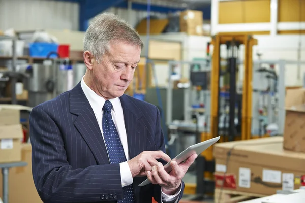 Factory Owner Using Digital Tablet