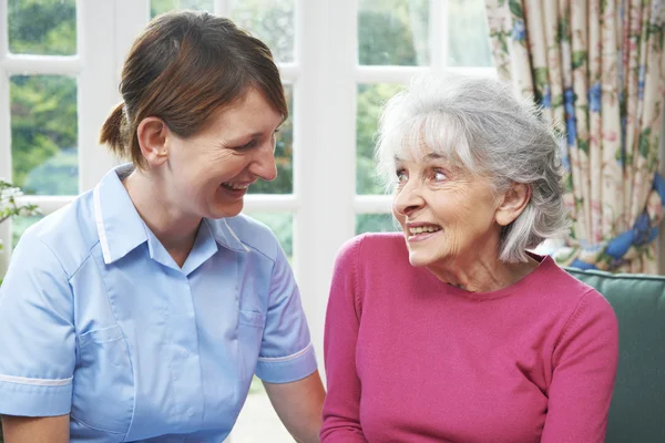 Senior Woman Chatting With Carer
