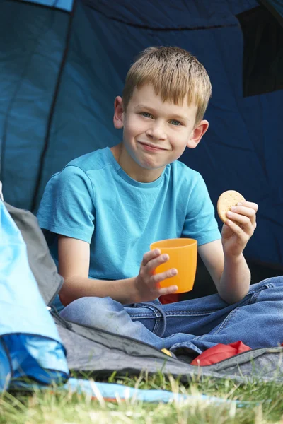 Boy Having Snack On Camping Trip
