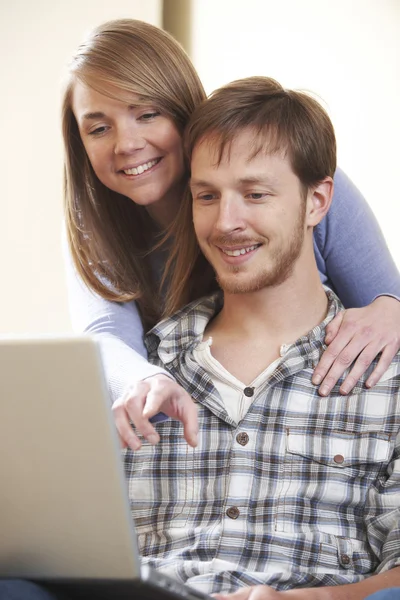 Young Couple Looking At Laptop Together