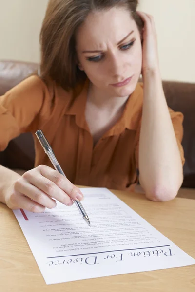 Worried Young Woman Completing Petition For Divorce