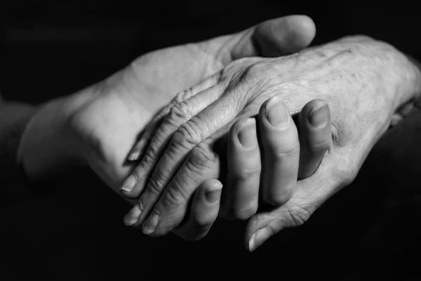 Monochrome Shot Of Young Woman Holding Older Woman\'s Hand