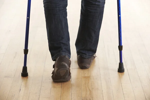 Close Up Of Man Using Crutches
