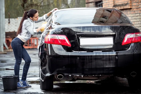 Girl washes the car