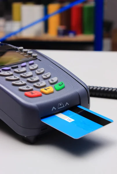 Payment terminal with credit card on desk in shop