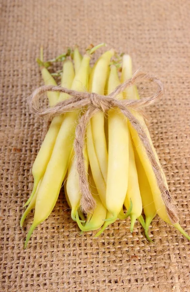 Stack of yellow beans on jute canvas, healthy food