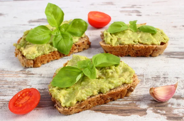 Freshly sandwiches with paste of avocado and ingredients, healthy food and nutrition