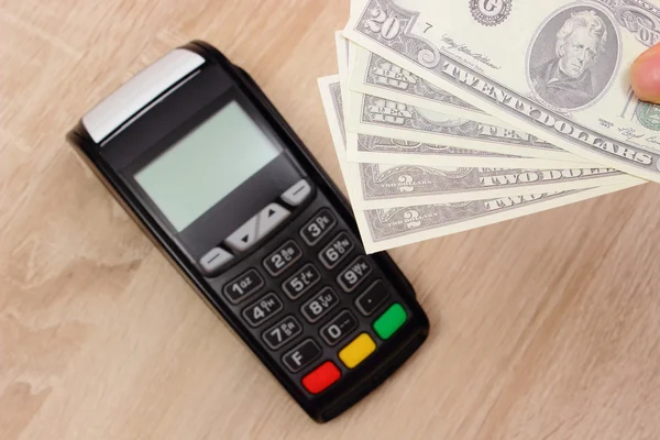 Payment terminal with money, credit card machine on desk, finance concept