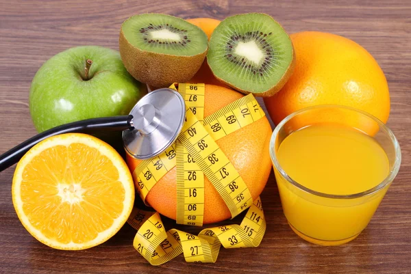 Stethoscope, fresh fruits, juice and centimeter, healthy lifestyles and nutrition