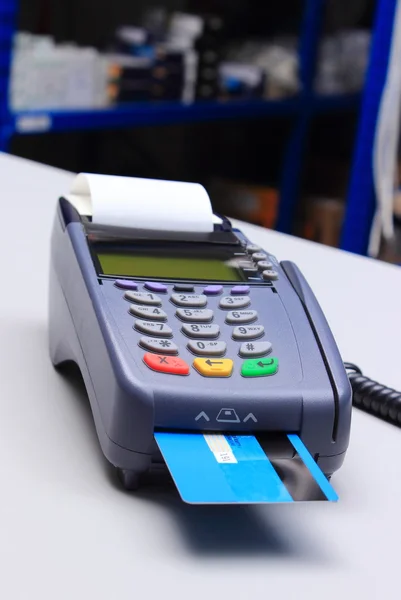 Payment terminal with credit card on desk in shop