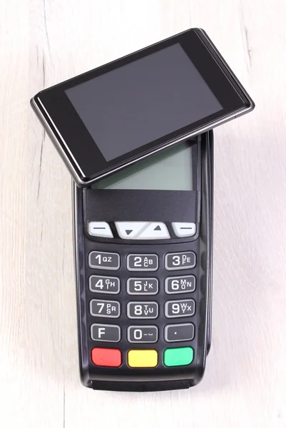 Payment terminal and mobile phone with NFC technology, cashless paying for shopping or products