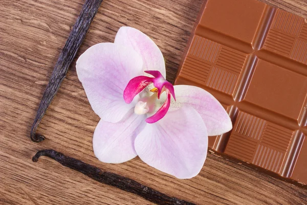 Milk chocolate, fragrant vanilla sticks and blooming orchid