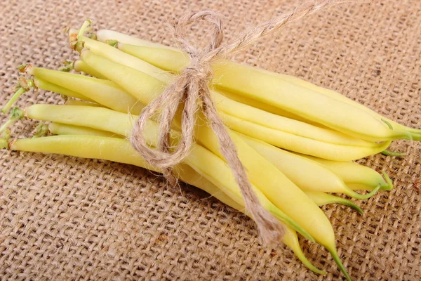 Stack of yellow beans on jute canvas, healthy food