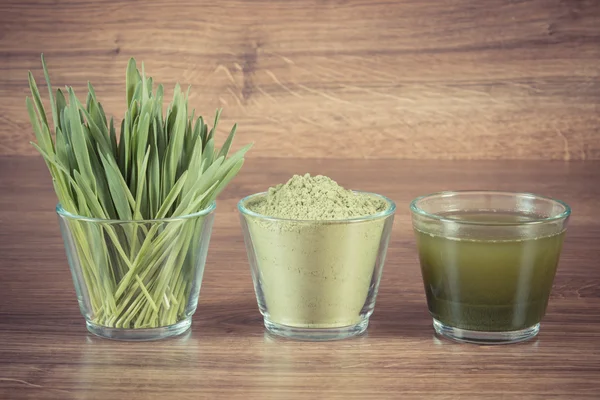 Vintage photo, Heap of young powder barley, barley grass and beverage on wooden background