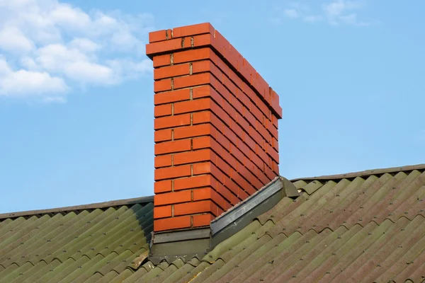 Chimney on roof of house on sunny day