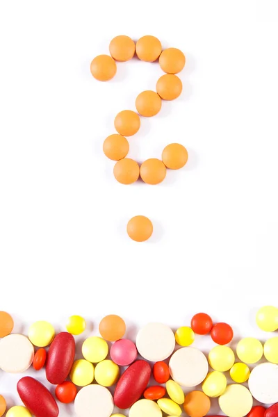 Question mark made of medical pills and tablets on white background, health care concept