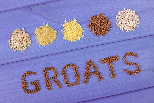 Inscription groats and various groats on wooden boards, healthy food and nutrition