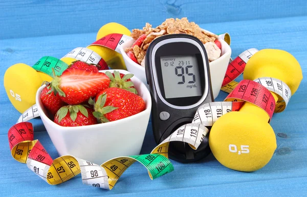 Glucometer with sugar level, healthy food, dumbbells and centimeter, diabetes, healthy and sporty lifestyle