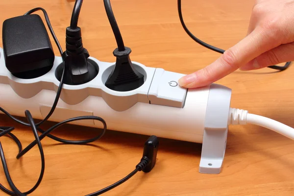 Electrical cords connected to power strip, concept of energy saving