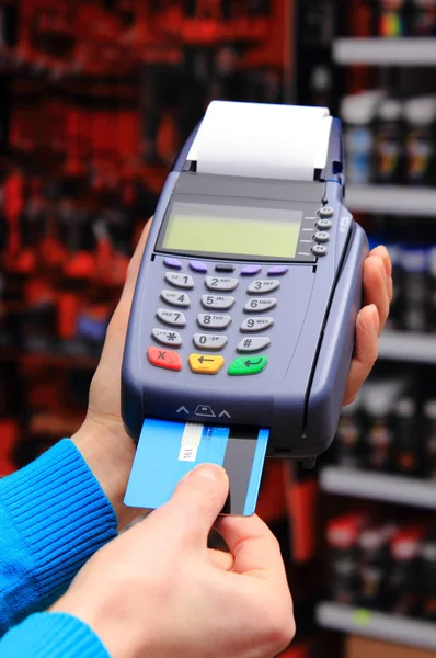 Paying with credit card in an electrical shop, finance concept