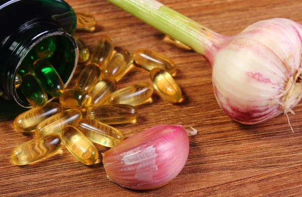 Whole garlic and clove with pills, alternative medicine