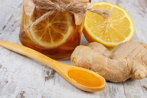 Fresh lemon, honey and ginger on wooden table, healthy nutrition