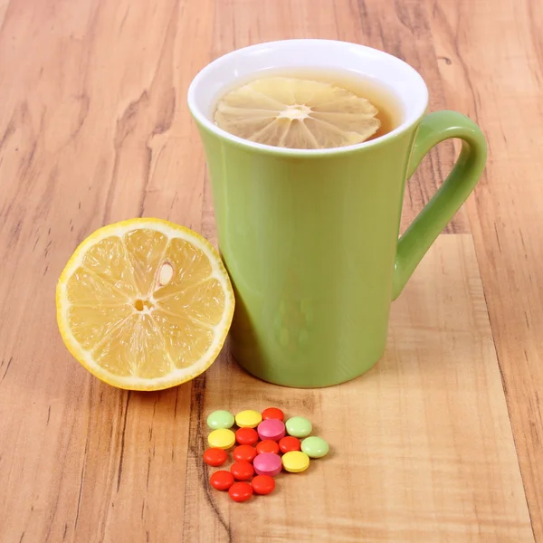 Pills and hot tea with lemon for colds, treatment of flu and runny