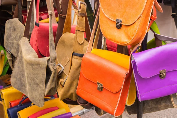 Collection of leather handbags on stall at the bazaar