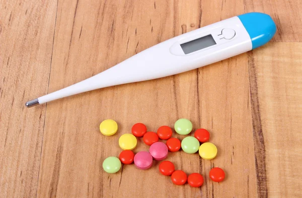 Thermometer and pills for colds, treatment of flu and runny