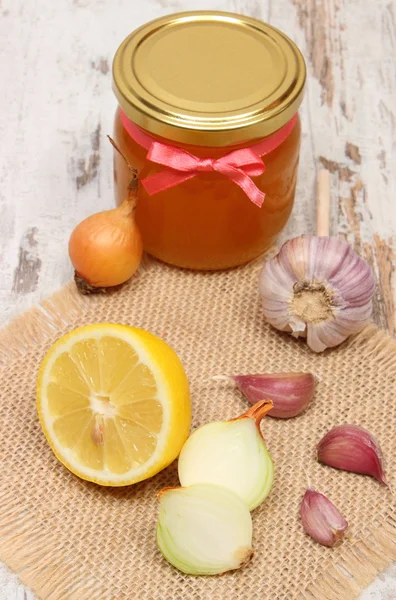 Onion, garlic, lemon and honey in glass jar, healthy nutrition and strengthening immunity