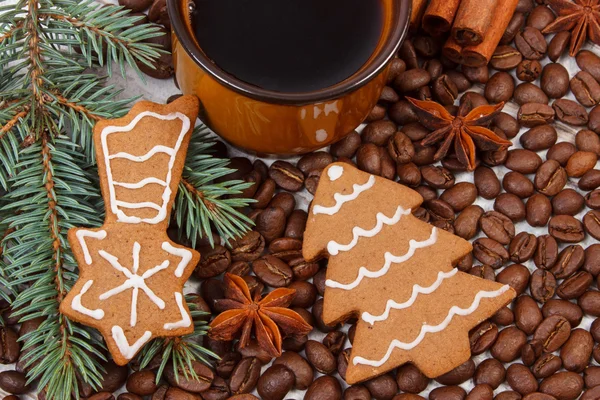 Fresh gingerbread, cup of coffee and grains, spices, christmas time